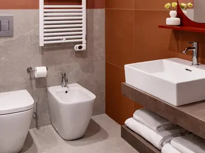 a bathroom with a white toilet and a sink at Numa Rome Trastevere in Rome