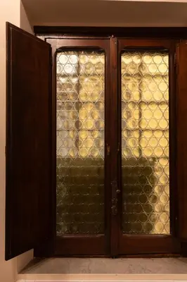 a wooden door with glass windows in a room at the secret terrace - navona in Rome