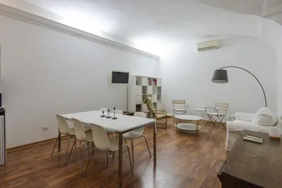 a living room with a white table and chairs at Vatican Luxury Three Bedroom Apartment in Rome