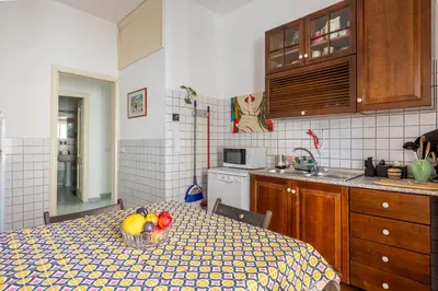 a kitchen with a table with a bowl of fruit on it at Atelier Latino in Rome