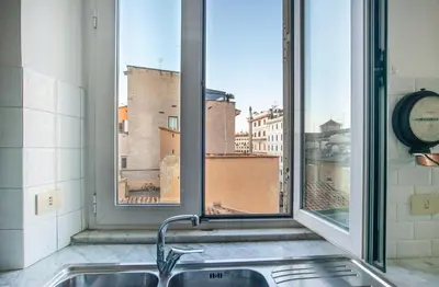 a kitchen sink with a view of a window at Urban Terrace Merulana - by OpenRoma in Rome