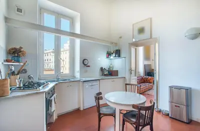 a kitchen with a table and chairs and a table at Urban Terrace Merulana - by OpenRoma in Rome