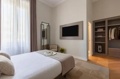 a hotel room with a bed and a tv at Decòncept House in Rome