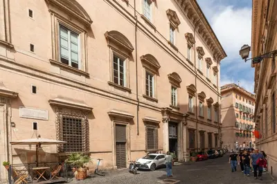 a group of people walking down a street next to buildings at Pantheon Palace Loft by RomeLoft in Rome