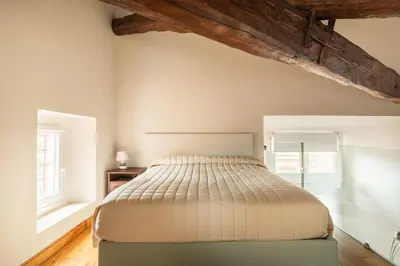 a bedroom with a bed and two windows at Pantheon Palace Loft by RomeLoft in Rome