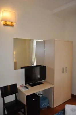 a room with a desk with a tv and a mirror at Karina Suite in Rome