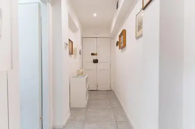 a hallway with white walls and a white door at Jubilee Metro A 15 minutes from the Colosseum in Rome