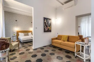 a living room with a couch and a bed at 101 Flats Candia's Suites in Rome