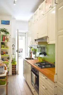 a kitchen with white cabinets and a stove top oven at Home in Parioli in Rome