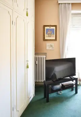 a living room with a flat screen tv in a room at Home in Parioli in Rome