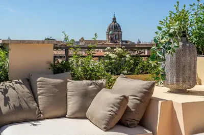 a couch sitting on top of a balcony at iFlat Spanish Steps Unique Panoramic Penthouse in Rome