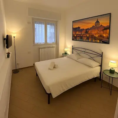 a bedroom with a bed and a painting on the wall at Casa Garbata in Rome