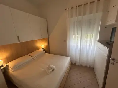 a bedroom with a bed with a towel on it at Casa Garbata in Rome