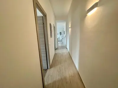 a hallway with a mirror and a long hallway at Aurum Homes - Vaticano Lux Appartament in Rome