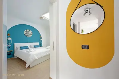 a bedroom with a yellow mirror and a bed at Color House, roof garden & parking in Rome