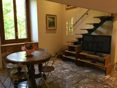 a living room with a table and a television at Casa Betania in Rome