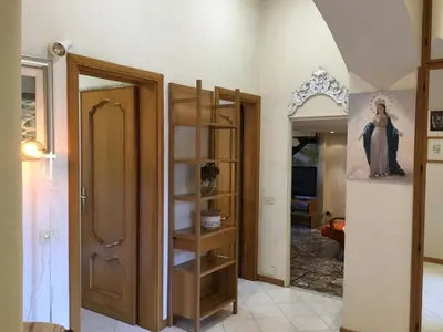 a room with a door and a shelf with a statue at Casa Betania in Rome