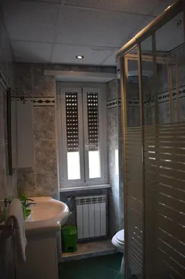 a bathroom with a sink and a toilet at Appartamenti Romolo E Remo in Rome