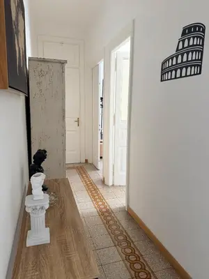 a hallway with a dog sitting on the floor of a room at Qflat Elegant Palumbo Vatican in Rome