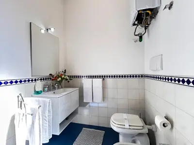 a kitchen with a table and a yellow wall at DomusVaticano in Rome
