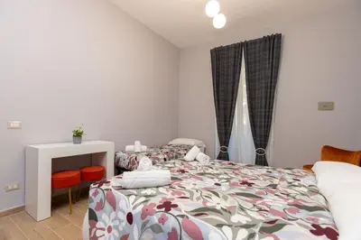 a bedroom with a bed and a table and chairs at Casa di latta in Rome