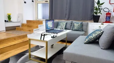 a laptop sitting on a table in a living room at Monolocale Stadio olimpico Francia Suite in Rome