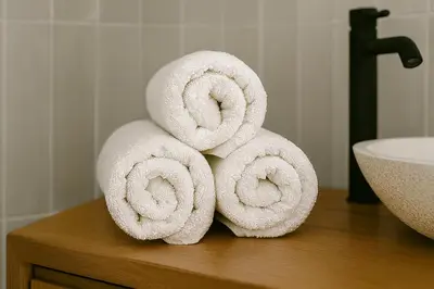 a pile of towels on a counter next to a sink at NERI Vatican Suite in Rome