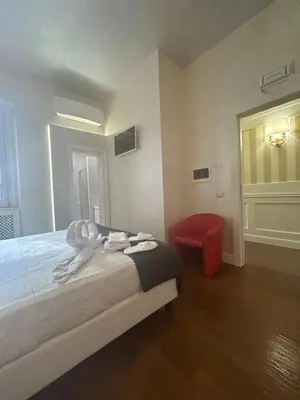 a bedroom with a bed with a statue of a person on it at Piazza Venezia appartamento con vista in Rome