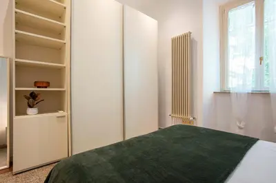 a bedroom with a bed with a green blanket at Casa Mia in Rome
