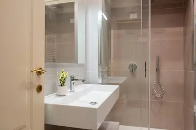 a bathroom with a white sink and a shower at Casa Mia in Rome