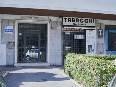 a building with a garage with a car parked in it at La Casa dei Lettori in Rome