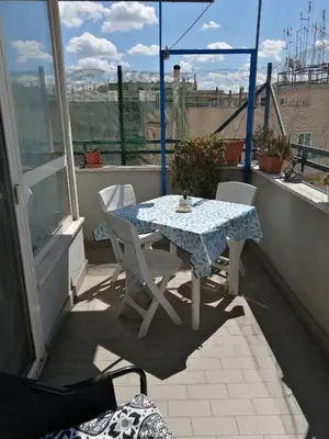 a table and chairs sitting on a balcony at Il Melograno - Just like at home! in Rome
