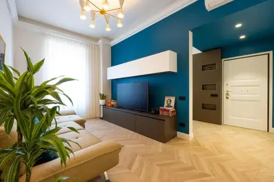 a living room with blue walls and a couch at Casa Lilla in Rome