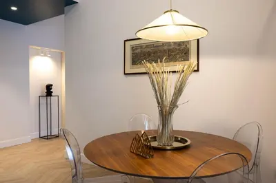 a dining room table with a vase of flowers on it at Casa Lilla in Rome
