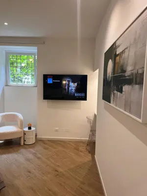 a living room with a flat screen tv on a wall at Casa Vacanze Villa Barberina in Rome
