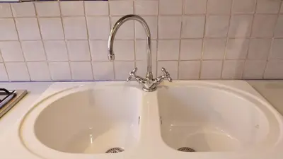a white sink with a faucet in a kitchen at A Casa di Vittoria in Rome