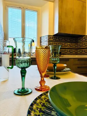 a table with four wine glasses sitting on it at CasaNa' in Rome