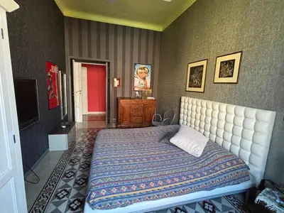 a bedroom with a large bed and a television at Casa Alessia a Roma in Rome