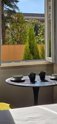 a table with four bowls on it with a window at Elegante Stanza Privata in Centro a Roma Colosseo - FLC Room in Rome in Rome