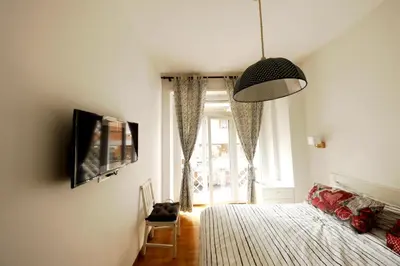 a bedroom with a bed and a tv and a window at P-House in Rome