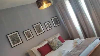 a bedroom with a bed and pictures on the wall at Ostiense station penthouse in Rome