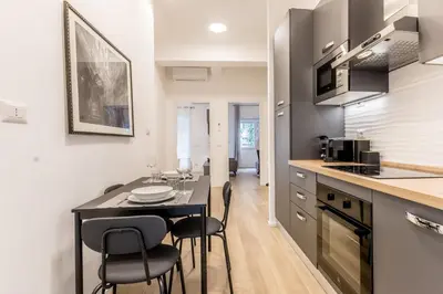 a kitchen with a table and chairs in a room at Domus urbe San Paolo in Rome