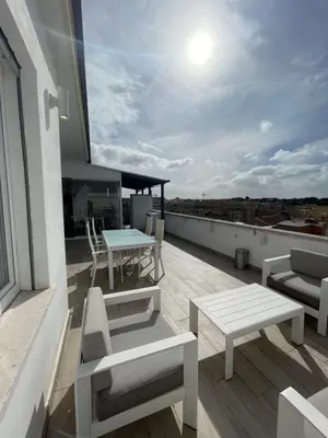a balcony with a table and chairs on a roof at YCH-Attico con splendida vista su Villa Ada in Rome