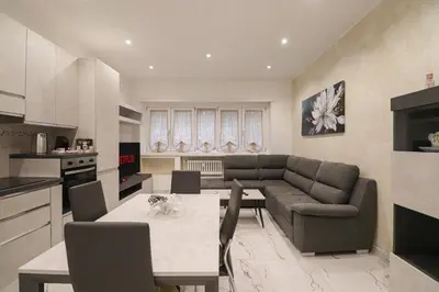 a kitchen and living room with a couch and a table at Vatican Splendid Dream Apartment in Rome