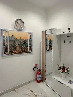 a bathroom with two windows and a clock on the wall at Vatican Splendid Dream Apartment in Rome