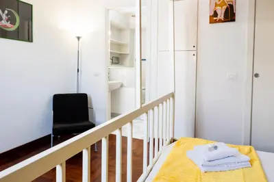 a room with a staircase with a black chair at Casa Medea in Rome