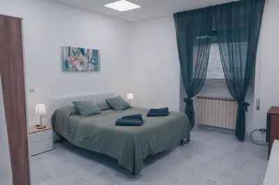 a bedroom with a bed with blue pillows on it at Daniela's Home vicino a Metro A e Vaticano in Rome
