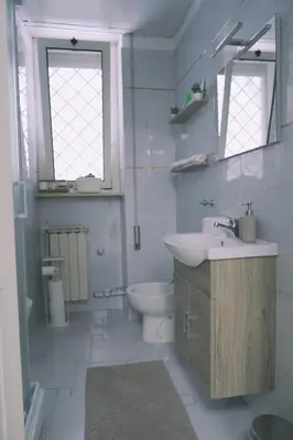 a white bathroom with a sink and a toilet at Daniela's Home vicino a Metro A e Vaticano in Rome