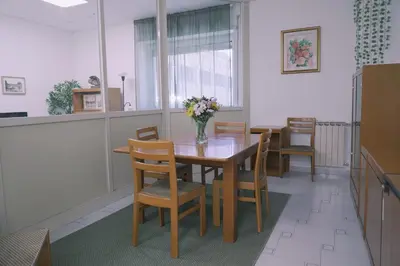 a dining room with a table and chairs and a vase of flowers at Daniela's Home vicino a Metro A e Vaticano in Rome