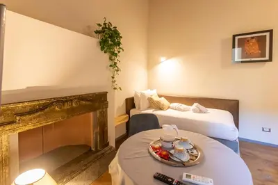 a hotel room with two beds and a fireplace at Fontana di Trevi Roma Luxury in Rome